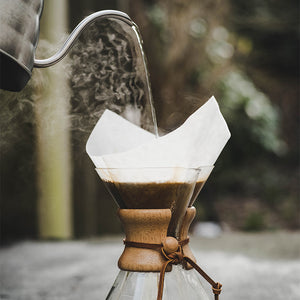 Freshly roasted carbon-offset coffee being brewed in a Chemex